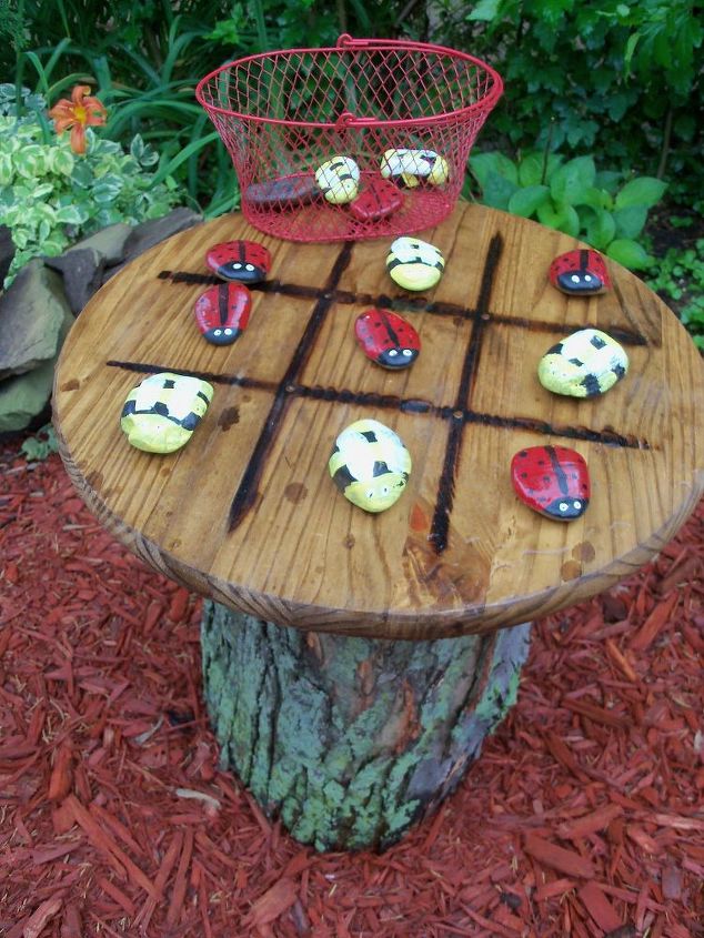 tic tac toe garden table, tic tac toe tree trunk table with stones painted as bees and lady bugs