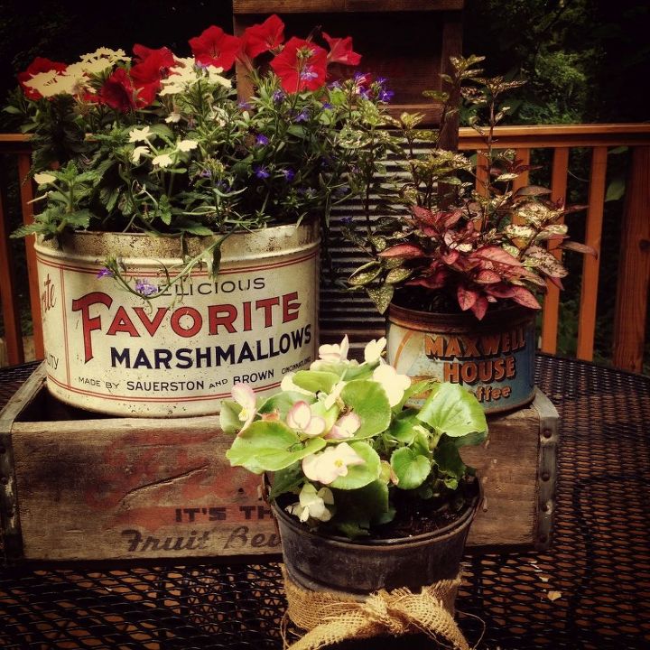 adding vintage junk to the garden, container gardening, flowers, gardening, repurposing upcycling, Flowers planted in vintage containers are grouped with an old washboard and soda crate to create a junky chic patio table vignette vintagejunk vintagetins