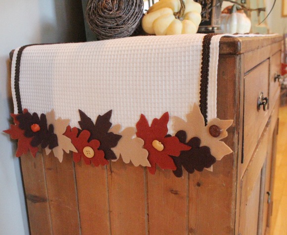 fabulous no sew fall leaf runner, crafts, seasonal holiday decor, Using three colors of felt and some waffle weave fabric and leftover buttons I created this cute Fall Leaf Runner for my foyer cabinet