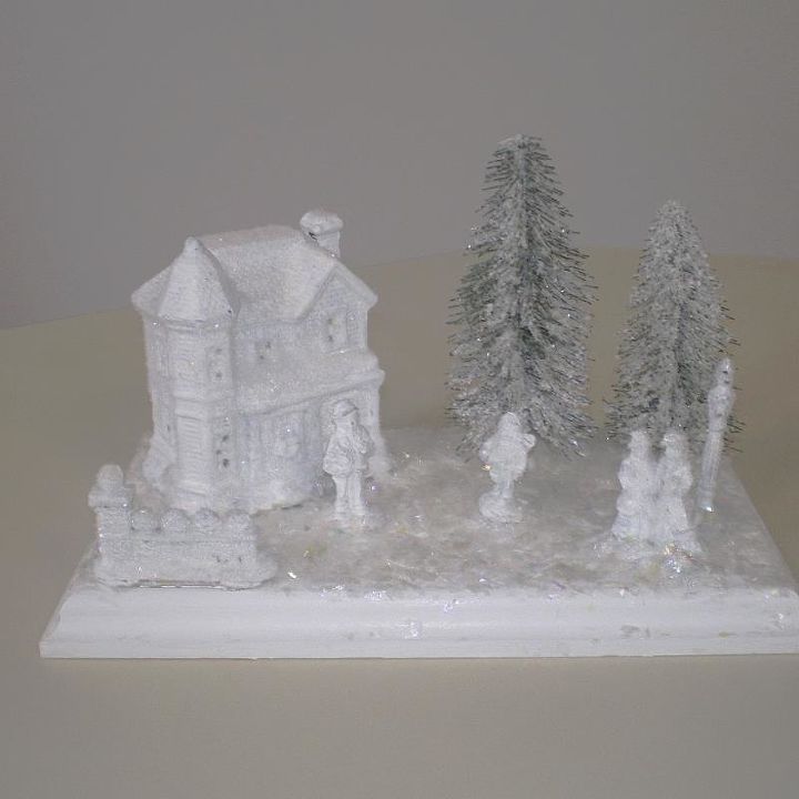 easy dollar store winter village, crafts, seasonal holiday decor, I sprayed the painted village pieces with clear acrylic matt spray for adhesion then dusted everything with snow After they dried I hot glued them to the board I then mod podged the board and added vintage snow