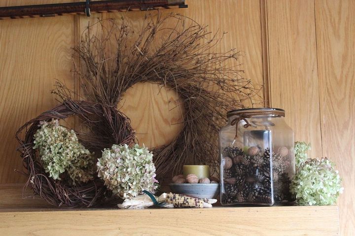 natural materials decorate small house thanksgiving mantle, seasonal holiday d cor, thanksgiving decorations, wreaths, Grapevine wreath layers nuts Indian corn and the beauty of fresh hydrangea blooms