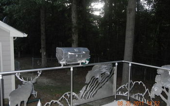 steel railing, insert of bear and small stainless grill mounted to railing