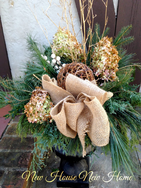 nature inspired holiday decor, christmas decorations, seasonal holiday decor, wreaths, Using what I had on hand and adding some natural elements like burlap ribbon and a grapevine ball gave the urns by the front door a natural casual look