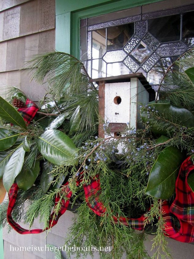 potting shed christmas nesting feathering, christmas decorations, decks, gardening, seasonal holiday decor, wreaths, A birdhouse is perched in the window box along with magnolia cedar cypress and pine A tartan ribbon swags through for a little color