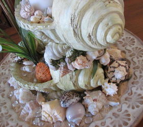 sea shell centerpiece, crafts, home decor, I sat it in a round tray that has a inner scallop design filled the tray with sand shells and clear glass rocks