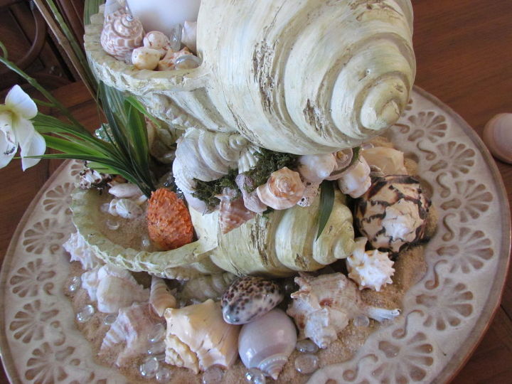 sea shell centerpiece, crafts, home decor, I sat it in a round tray that has a inner scallop design filled the tray with sand shells and clear glass rocks