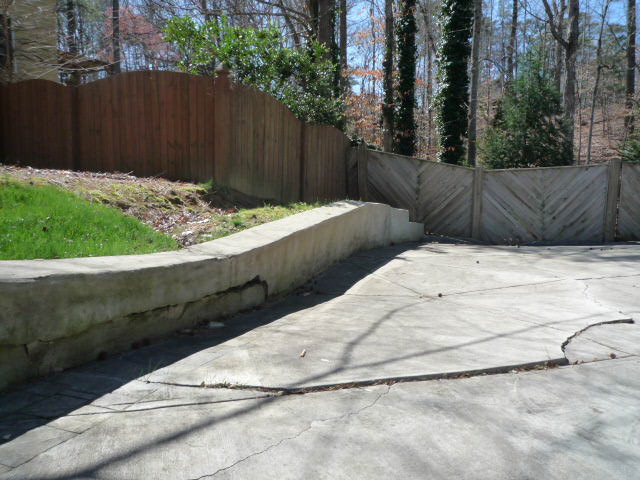 i really want to remove part of the retaining wall, Ground behing fence at end of driveway slopes down maybe 10 to the backyard