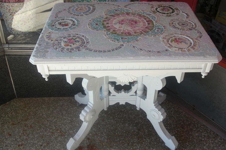 This is a commission piece I did for a woman. This table was her grandmother's and the top was not in the best of shape. She wanted it painted white and told me to do any design I wanted out of pastel colors. When she came to look at it, she was overwhelmed because one of the dishes (unbeknownst to me) was some identical dishes that her grandmother had.