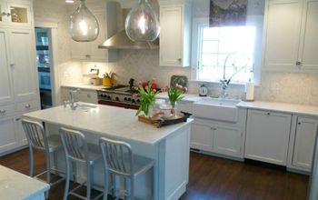 100 Year Old Kitchen Reno-red stove pops in a white kitchen with carrara marble.  Demijohn lights add drama #Bestof2012