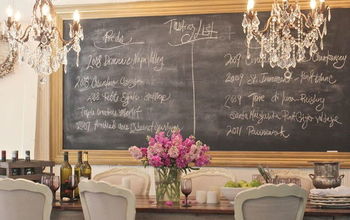 Double chandeliers with double the bling ;) and a big chalkboard help create a charming cottage dining room