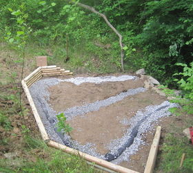 creating a creek stone patio fire pit, Then he dug a trench installed the french drain basically a pipe with holes in the top that collects water channels it where you want it to go covered it with gravel Then he added a timber retaining wall