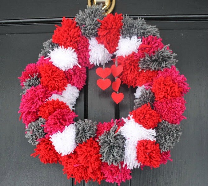 15 insanely smart hanger hacks you ll wish you d seen sooner, Make a pom pom Valentine s wreath
