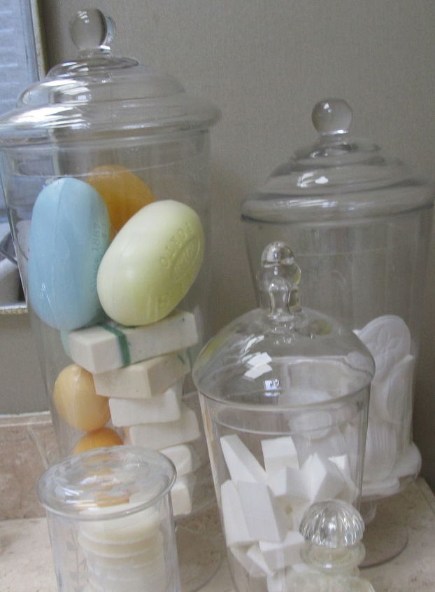organizing tips for the bathroom, bathroom ideas, organizing, Metropolitan Organizing NC Squeaky clean glass apothecary jars are one way to categorize and display soaps cotton pads makeup wedges Q tips and other bathroom essentials