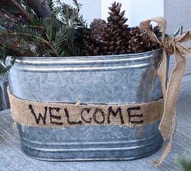 winter front porch decorating, crafts, seasonal holiday decor, Galvanized bucket display on my front porch The pine springs logs and pine cones with a little burlap bow just make me smile