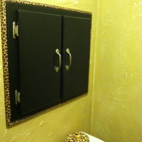 my animal print powder room, home decor, painting, The wall inset cabinet was a dark walnut so I sanded it and painted it black The quarter round trim was cut to size and assembled then decoupaged I didn t need to nail it on it fit snug against the wall so when I want to remove it off