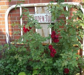 gardening in repurposed planters, gardening, repurposing upcycling, This is an old iron bed that I m using as a trellis for our roses