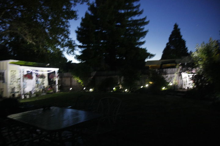 nightime in the cottage garden, lighting, outdoor living, click on picture to see whole back yard lighting have more lights to add to other bushes that are solar but for now this is my solar lighting for back corner