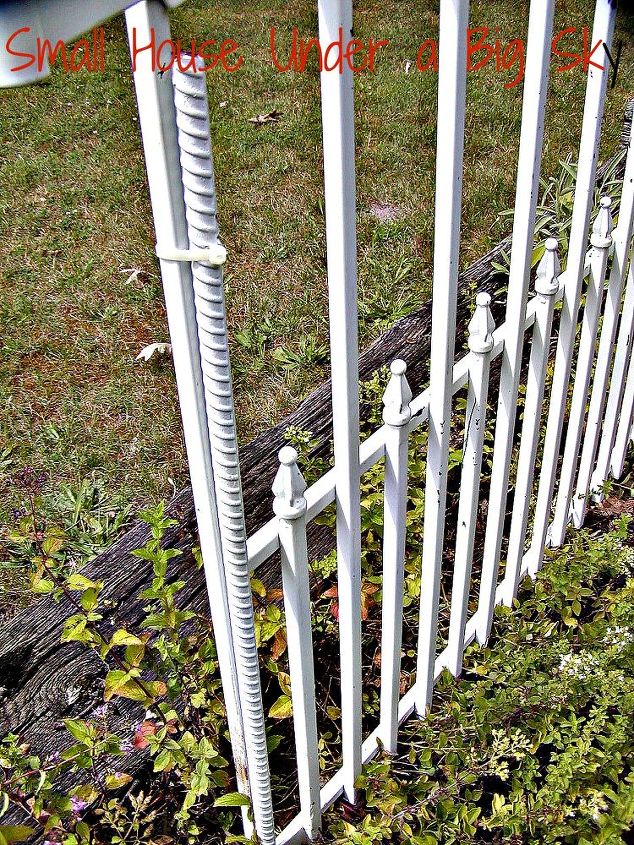 metal dog gate repurposed into decorative garden accent, fences, gardening, repurposing upcycling, Spray painted rebar attached to the gate provides the spike to hold the gate in the soil