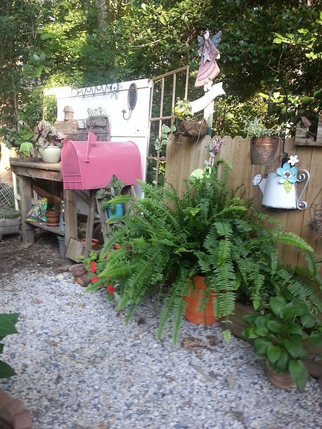 welcome to my potting area and nursery, gardening, outdoor living, repurposing upcycling, Peaking in