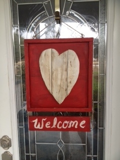 valentine s day welcome sign wood scraps, crafts, seasonal holiday decor, valentines day ideas, woodworking projects, The backdrop for the heart is made from 2 pieces of oak plywood 2 scraps put together then I cut to length and stapled 1x1 to frame it The heart is made from 1x4 furring strips I traced my heart out line on the wood and used a jigsaw to cut out the heart Then cut another furring strip to match the width of the heart frame and painted Welcome on it