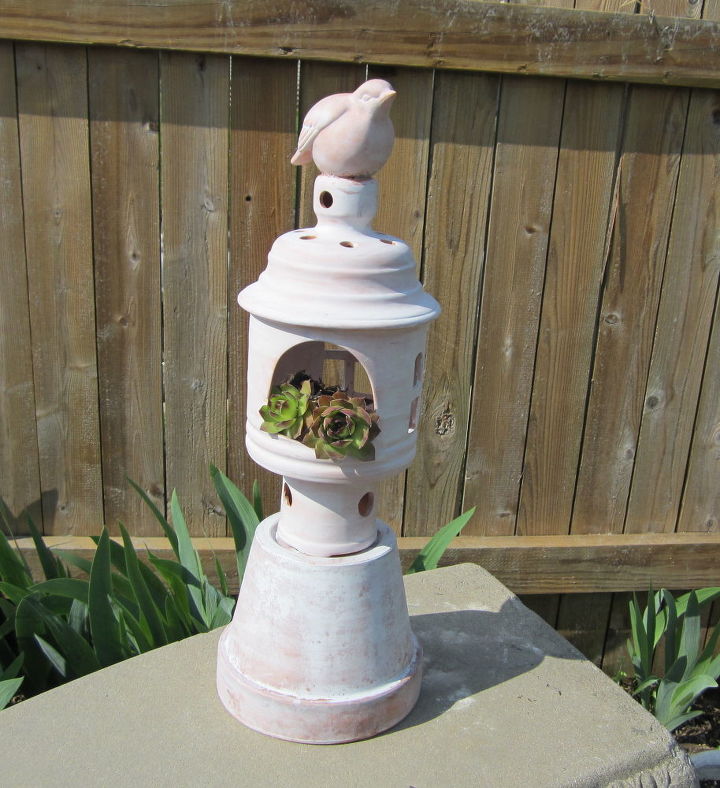started a garden art project and ended up with a dinning room centerpiece, flowers, home decor, Using four separate Terra Cotta pieces I found at the local Good Will and some silicone glue to start I assembled and white washed Thought I would use it in the garden with Hens and Chicks but I wasn t thrilled with the result