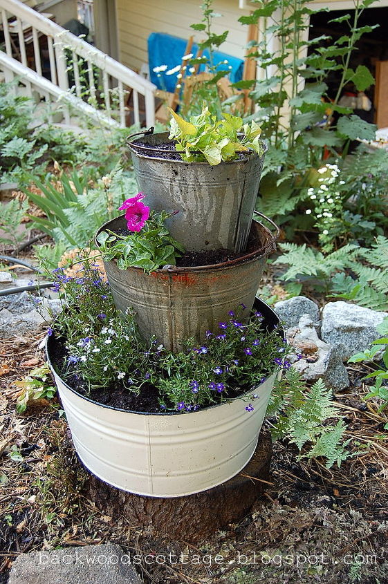 old buckets and flowers, flowers, gardening, repurposing upcycling, Old buckets and flowers hide an ugly stump