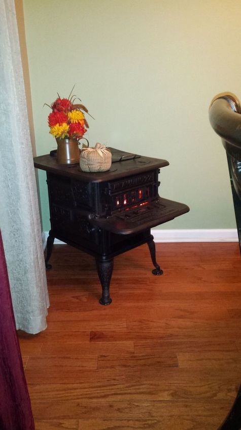 q how to restore an old cast iron wood burning stove, diy, how to, painted furniture, repurposing upcycling, My dad took this picture over Thanksgiving 2015 It felt really good to see the look on my parents faces I even threw some orange LED lights in the for decoration Maybe someday I ll actually be able to use it but not in the house