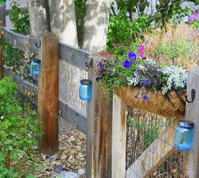 s 13 spectacular things to make for your yard using 1 solar lights, lighting, outdoor living, repurposing upcycling, These glassy blue fence lights