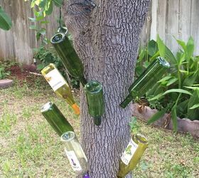 wine bottle garden decorations, outdoor living, repurposing upcycling