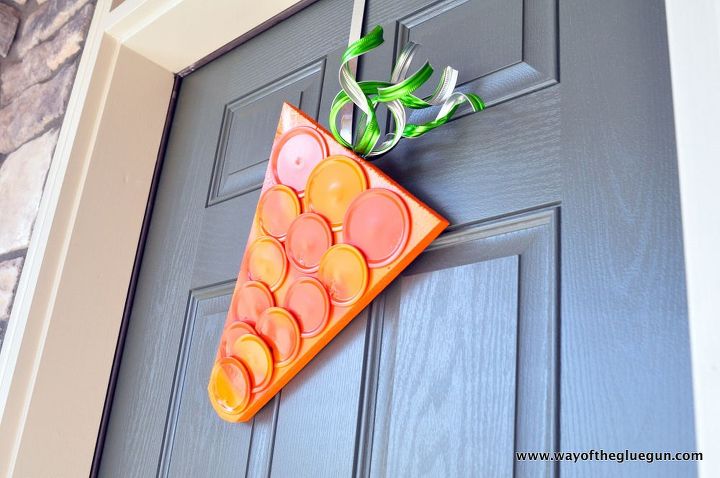 s 31 gorgeous spring wreaths that will make your neighbors smile, crafts, seasonal holiday decor, wreaths, Create a fun carrot hanger from canning lids