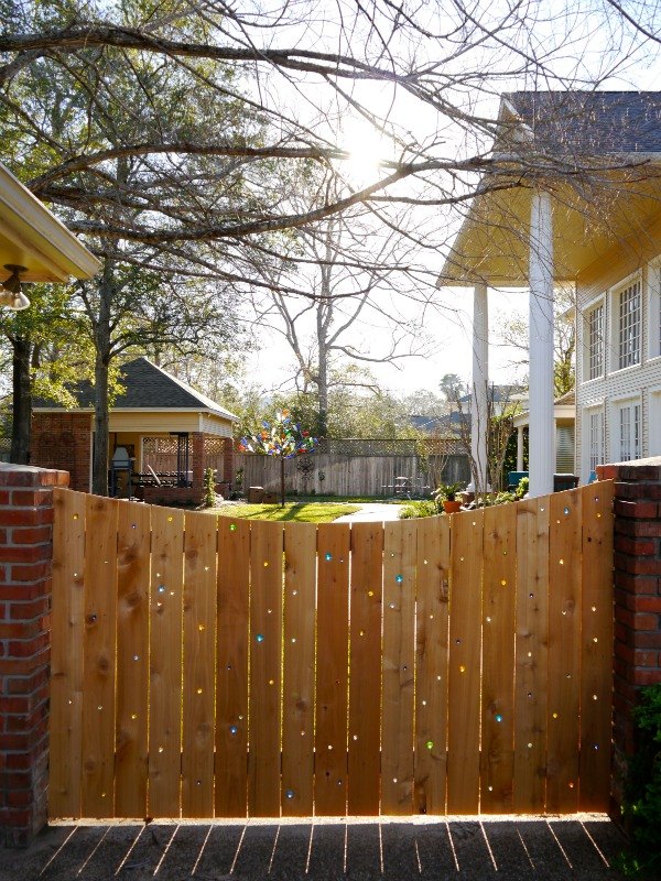 15 privacy fences that will turn your yard into a secluded oasis, Drill holes in a plain fence to add marbles