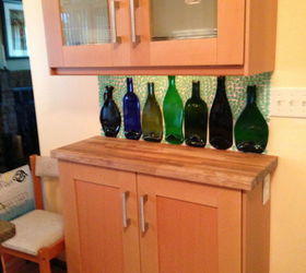 13 incredible kitchen backsplash ideas that aren t tile, Arrange slumped glass bottles on the wall