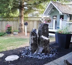 10 mini water features to add zen to your garden, Run a fountain through tall standing stones
