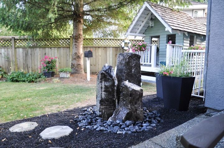 10 mini water features to add zen to your garden, Run a fountain through tall standing stones