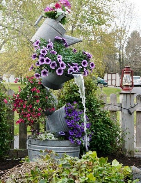 10 mini water features to add zen to your garden, Stack flower filled buckets into a tower