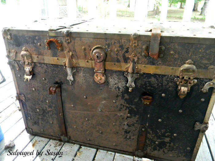 rusted vintage trunk makeover, The bottom has been scrubbed the top has not