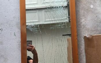 How do you remove broken glass from stand up mirror?