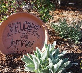 13 awesome ways to reuse a terra cotta saucer, Turn a broken saucer into a welcome sign