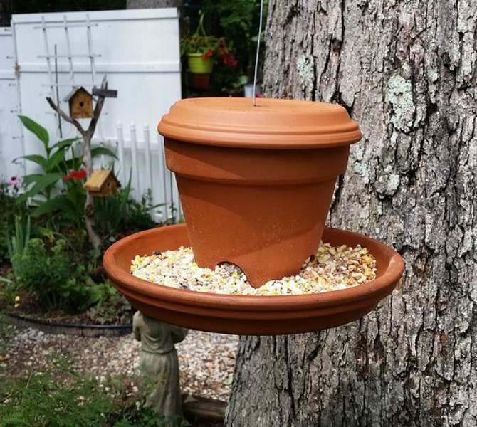 13 awesome ways to reuse a terra cotta saucer, Make a hanging bird feeder with a pot