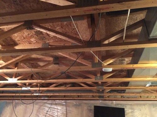 How can I make my basement's ceiling beam strong enough to