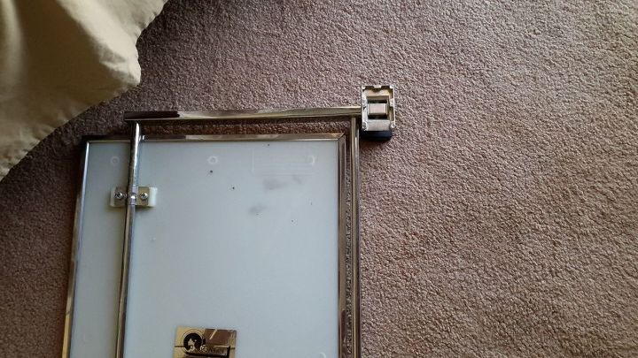 q need help finding new mirror brackets, home maintenance repairs, minor home repair, wall decor, Picture of the back of the mirror showing the mounts The mirror was sold originally as a SwingAway Style and View I ve called the number on the label but got no help at all