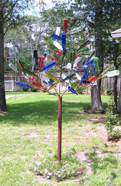 15 incredible backyard ideas using empty wine bottles, Make a bottle tree with stakes in the garden