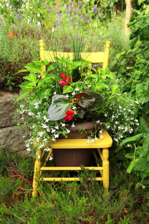 15 whimsical ways to use old furniture in your flower bed, Set a tall planter in a hollow chair center