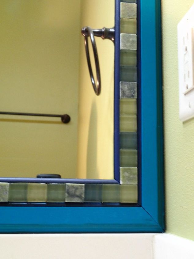 frame a mirror with moulding and tiles