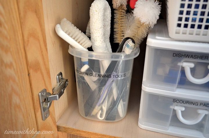 the 15 smartest storage hacks for under your sink, Store scrub brushes in a large plastic bucket