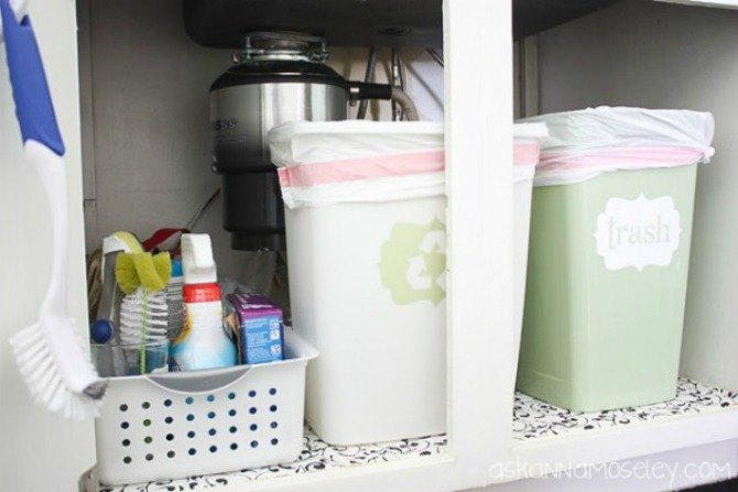 the 15 smartest storage hacks for under your sink, Stow small trash recycling bins on one side