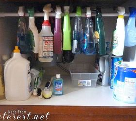 the 15 smartest storage hacks for under your sink, Hang a tension rod to hold spray bottles