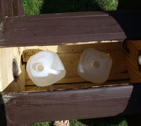 A gardener puts 2 milk jugs inside a spool for the coolest yard idea