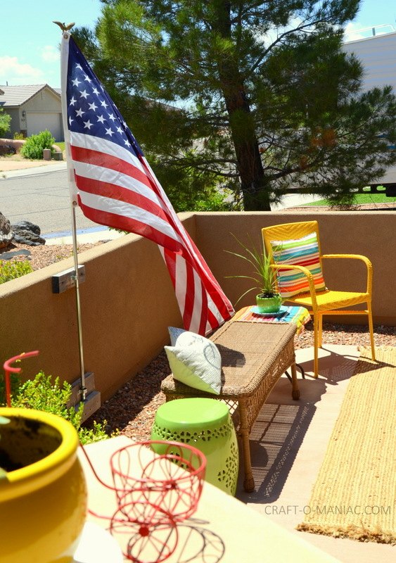 decked out summer porch decor, home decor, A summer flag whipping in the breeze