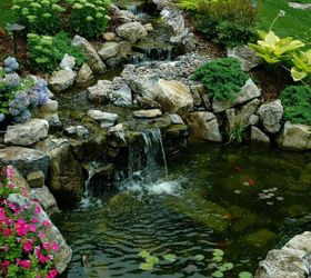 here s what people are doing with their sloped backyards, Add a bubbling pond at the bottom